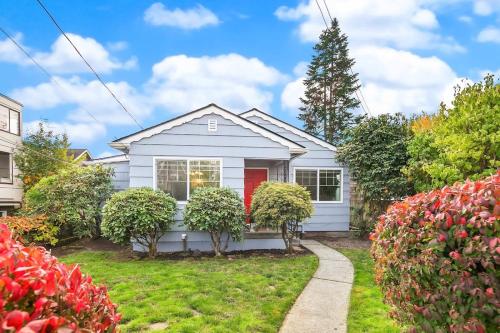 a white house with a red door at Hidden Getaway Family House - UW - Children Hospital in Seattle
