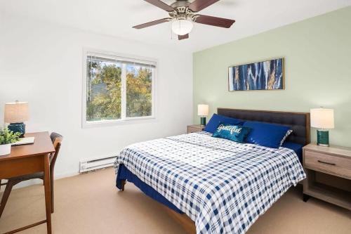 a bedroom with a bed and a desk and a ceiling fan at Hidden Getaway Family House - UW - Children Hospital in Seattle