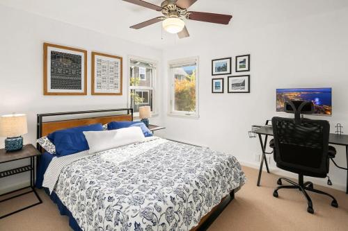 a bedroom with a bed and a desk and a ceiling fan at Hidden Getaway Family House - UW - Children Hospital in Seattle