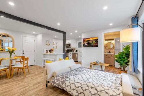 a bedroom with a bed and a dining room at Secret & Cozy Renovated Cottage Near Costco I99 in Shoreline
