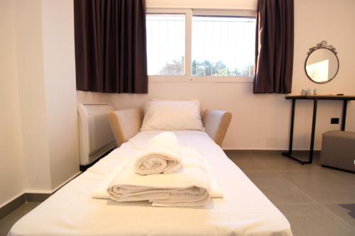 a hospital room with two beds and a mirror at Melina's Seaside Retreat in Ksamil