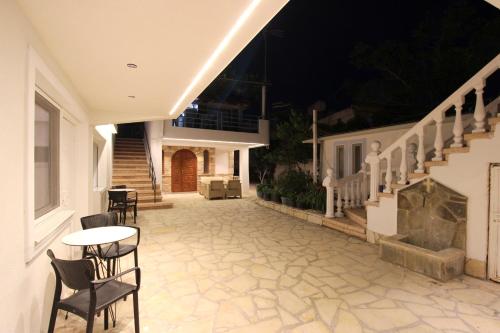 a patio with chairs and a table on a house at Melina's Seaside Retreat in Ksamil