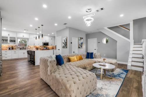 a living room with a couch and a table at Waterfront Home with Views - Hot Tub & Movie Theatre in Bacliff