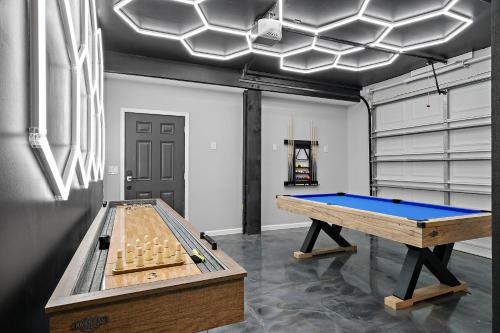 a ping pong table in a room with at Waterfront Home with Views - Hot Tub & Movie Theatre in Bacliff