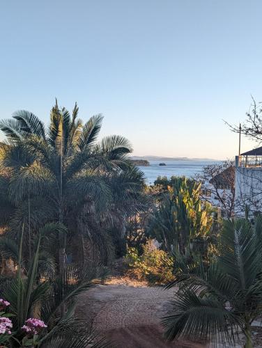 a view of a beach with palm trees and the ocean at Villa Cascada de Flores in Chacala