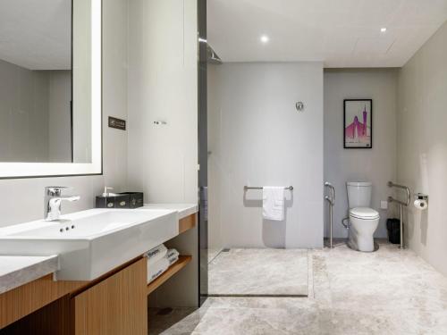 a bathroom with a sink and a toilet at Hampton by Hilton Guangzhou Baiyun Airport North in Huadu