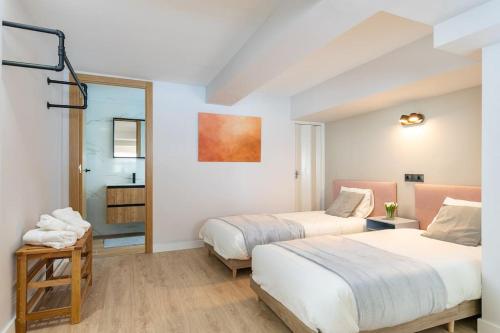 a hotel room with two beds and a mirror at Nice new duplex in front of Palacio VistaAlegre in Madrid