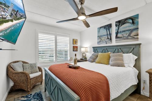 a bedroom with a bed and a ceiling fan at Beachside Bungalow: Surfside I #104 in South Padre Island