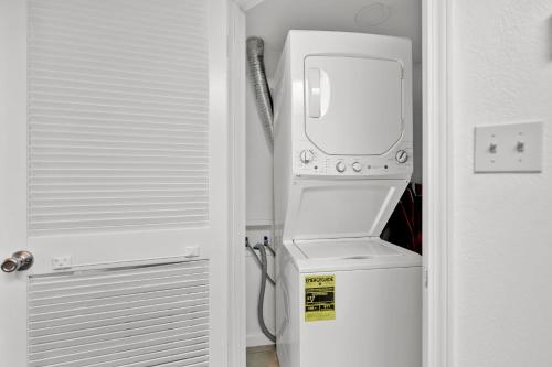 a white washer and dryer in a room at Beachside Bungalow: Surfside I #104 in South Padre Island