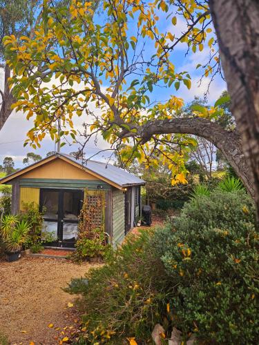 a small house in the middle of a garden at The Barn, Nungurner in Nungurner