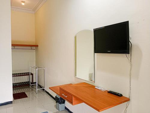 a room with a flat screen tv on a wall at Grand Palem Hotel in Songgoriti