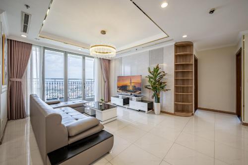 a living room with a couch and a tv at Vinhomes Central Park - PHAN DANG Residences in Ho Chi Minh City