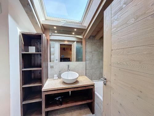 ein Badezimmer mit einem Waschbecken und einem Dachfenster in der Unterkunft Chalet Combloux, 7 pièces, 12 personnes - FR-1-560-138 in Combloux
