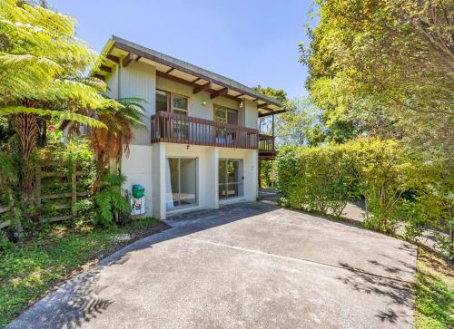 a house with a balcony and a driveway at 2 bedroom guest suite in North shore in Auckland