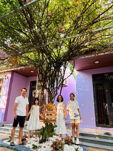 a group of people standing in front of a house at Son River House in Phong Nha