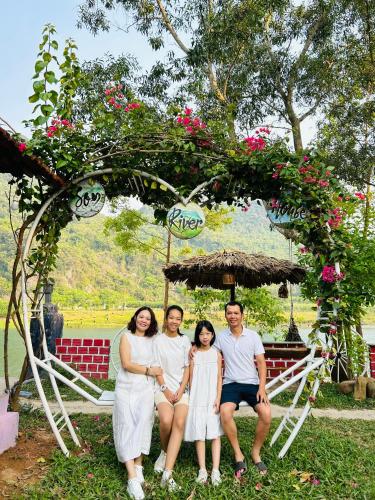 a group of people posing for a picture under a tree at Son River House in Phong Nha