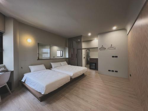 a large bedroom with a large bed and a bathroom at Yu Tainan BnB in Tainan