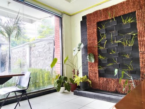 a room with a window with plants on the wall at Grand Palem Hotel in Songgoriti