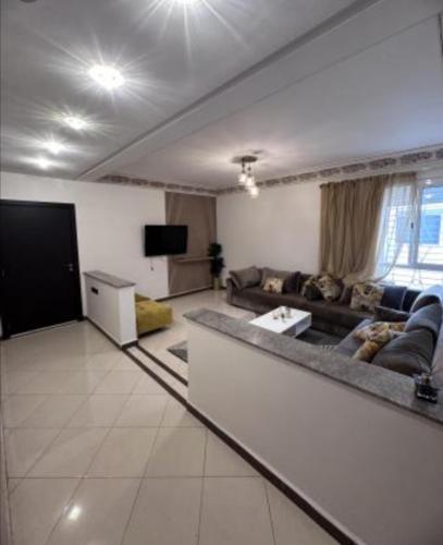 a large living room with a couch and a tv at إخامن in Khenifra