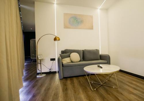 a living room with a couch and a table at Regatta at Kozi Square Kuching in Kuching