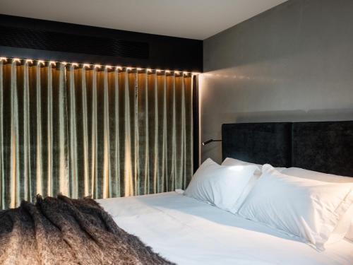 1 dormitorio con 1 cama con sábanas blancas y ventana en 'Sydney' - Luxurious waterfront penthouse in Battery Point, en Hobart