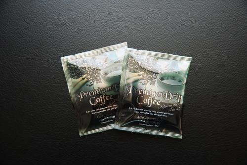 two plastic bags with a container of coffee at Solaria Nishitetsu Hotel Kagoshima in Kagoshima