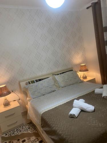 a bedroom with a bed with towels on it at apartment in the city center in Durrës