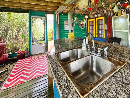 a kitchen with a sink and a counter top at Salty Dog Cottage in Surfside Beach