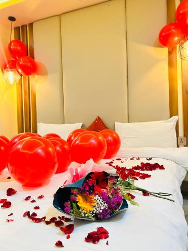 a bed with red balloons and flowers on it at Hotel Balgopal in Kathmandu