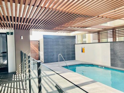 a large swimming pool in a building with a pool at CASSA TOOWONG - Convenient 1B Apt at Central Location with Parking Managed by The Cassa in Brisbane
