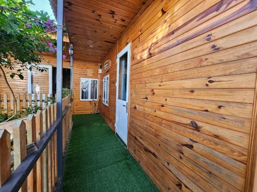 a wooden wall on a house with a hallway at Cherry Trại mát homestay in Trai Mat