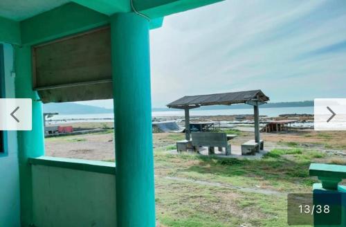 a view of a beach with a picnic shelter at Nias Falaga Home in Lagudri