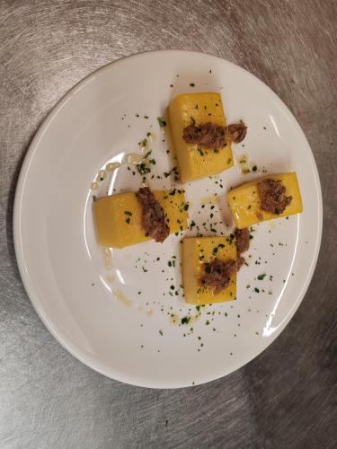 a white plate with some food on a table at HOTEL BELVEDERE in Rivalta di Brentino