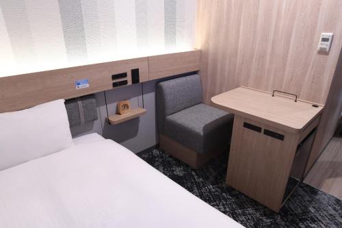 a small room with a bed and a desk and a sink at R&B Hotel Otsuka Eki Kitaguchi - Vacation STAY 40488v in Tokyo