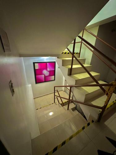 a staircase in a building with a picture on the wall at Hotel San Diego DOSQUEBRADAS in Dosquebradas