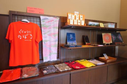 a display case with a red shirt and other items at hokkein-onsen kougen-terrace in Kokonoe