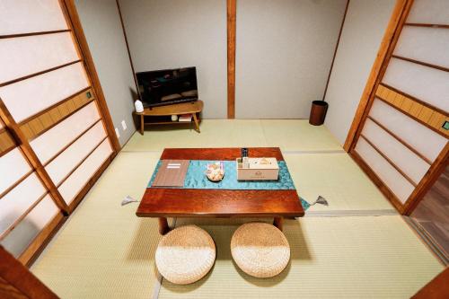 a living room with a table and a tv at M102Near Nagoya Station Machiya Max of 8 people in Chiharachō