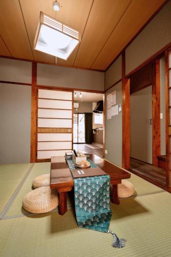 a living room with a table and some chairs at M102Near Nagoya Station Machiya Max of 8 people in Chiharachō