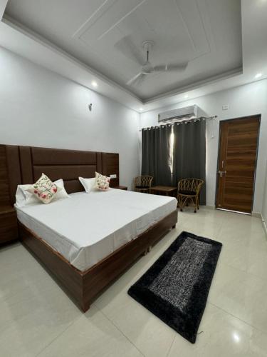 a bedroom with a large bed in a room at Hotel Yog Vriksh in Rishīkesh