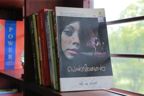 a book sitting on a book shelf at raison d'être - The Residential Library in Trivandrum