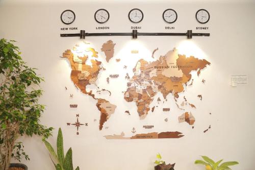 a map of the world on a wall with clocks at raison d'être - The Residential Library in Trivandrum