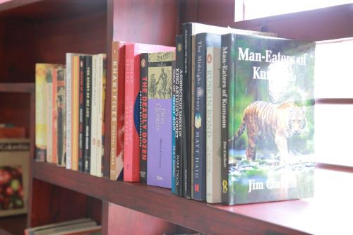 a row of books on a book shelf at raison d'être - The Residential Library in Trivandrum