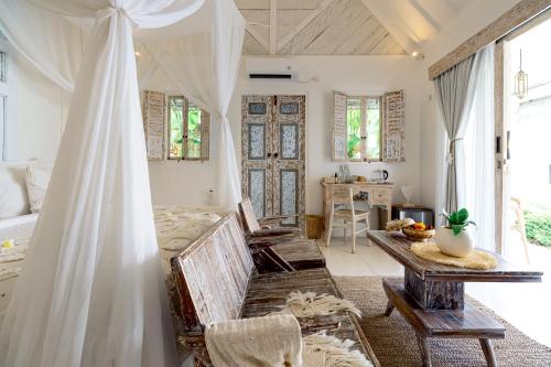 a bedroom with a bed and a table in a room at Atalaya Villas Nusa Penida - Adults only in Nusa Penida