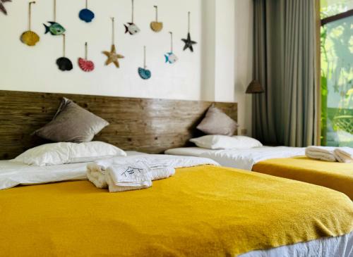 a bedroom with two beds with towels on them at 蓝色引力潜水度假村BLUE GRAVITY.WOW DIVING in Panglao