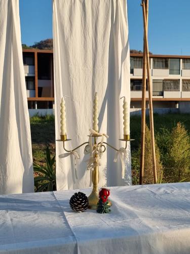 a table with a white table cloth and a vase on it at Charlee Khaoyai in Mu Si