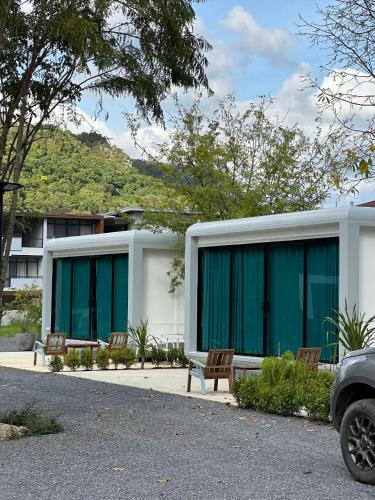 a building with windows and benches in front of it at Charlee Khaoyai in Mu Si