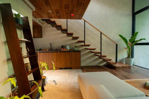 a living room with a spiral staircase in a house at Piece Lio Resort from Japan in El Nido