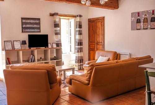 ein Wohnzimmer mit 2 Stühlen und einem TV in der Unterkunft Pegau Bed Room in Châteauneuf-du-Pape