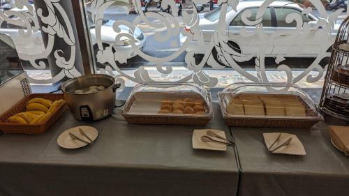 three baskets of donuts sitting on a table at Waugh Den Business Hotel in Taichung
