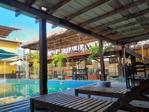 a patio with a table and chairs next to a pool at El Bunker 9 in Iquitos